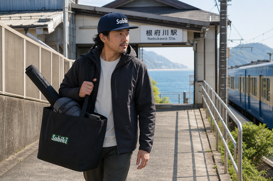 SABIKIキャップとトートで電車釣行へ向かう男性